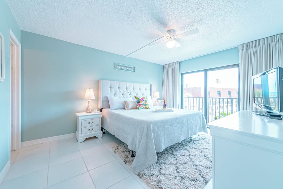 Serene master bedroom with a king bed, ensuite, walk-in closet, and TV.