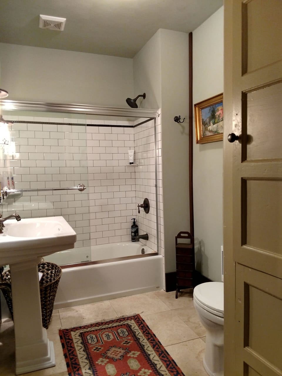 1st floor full bath w/tub, shower, subway tile, & Travertine stone floors