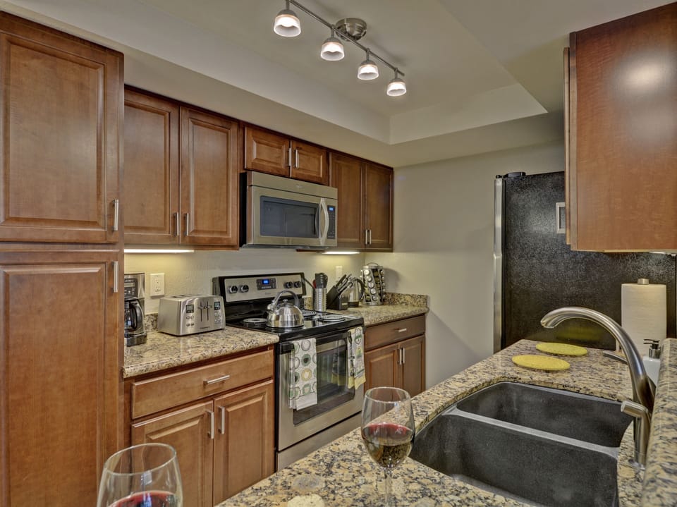 Fully equipped kitchen with stainless steel appliances & fully stocked kitchen.