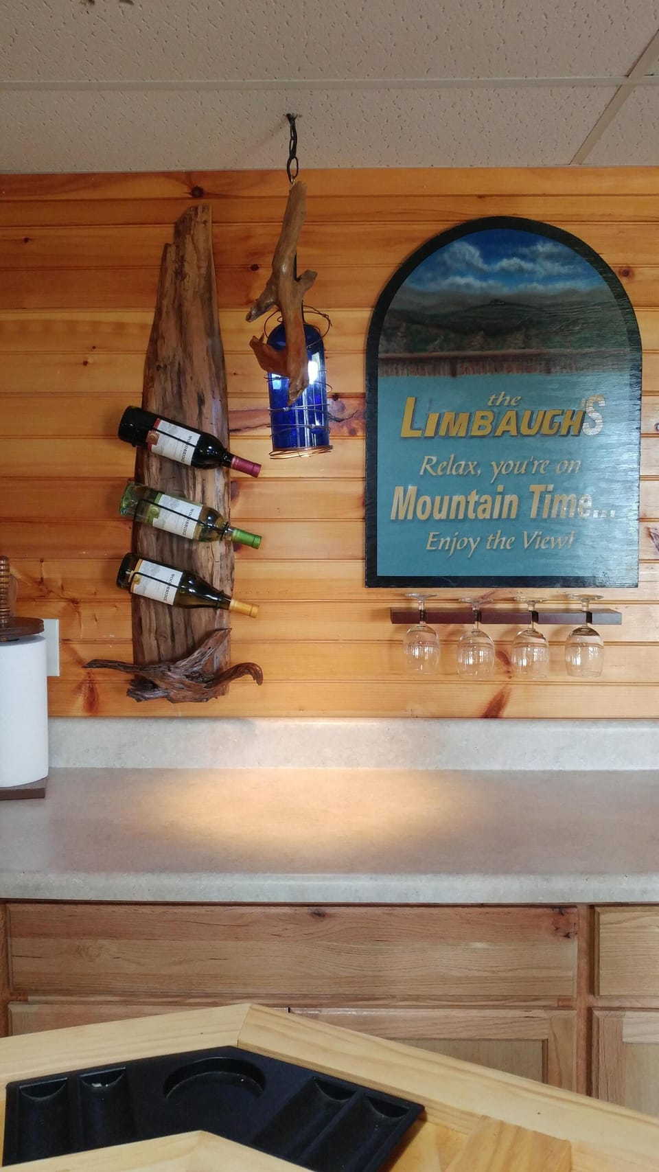 Bar in game room. Special live edge wine rack with driftwood accents.
