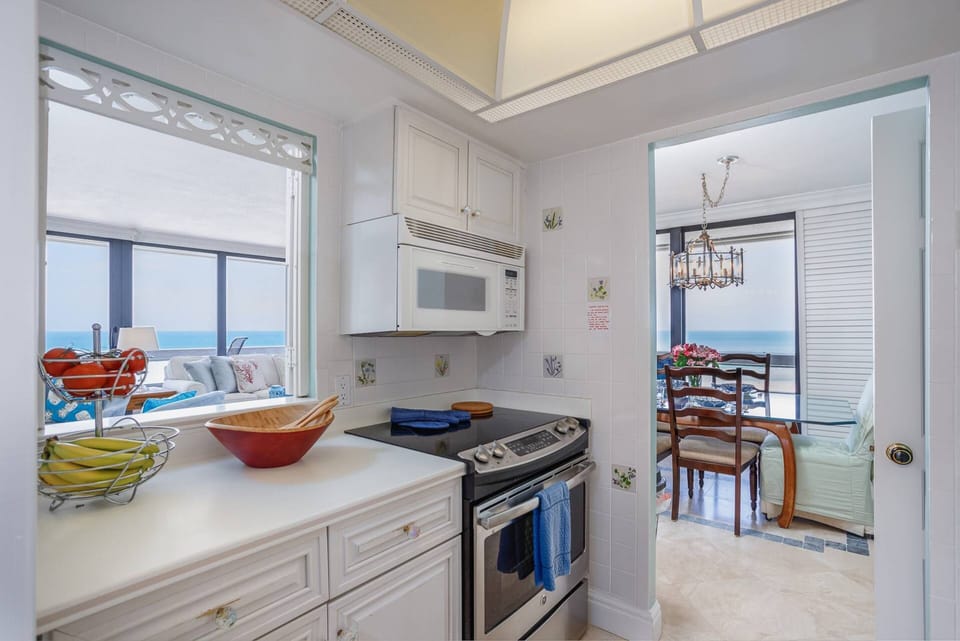 Kitchen has tile floors and ample counter space to enjoy homemade meals if you prefer.
