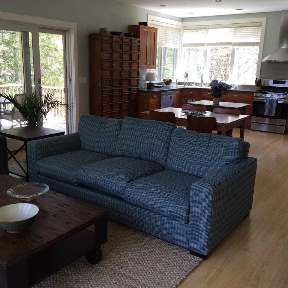 The living room looking into the dining area and kitchen.  The table seats 8.
