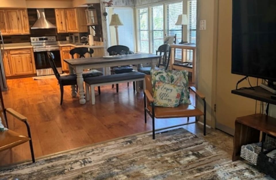 Living room and dining area in the upstairs suite. Windows overlook the lake.