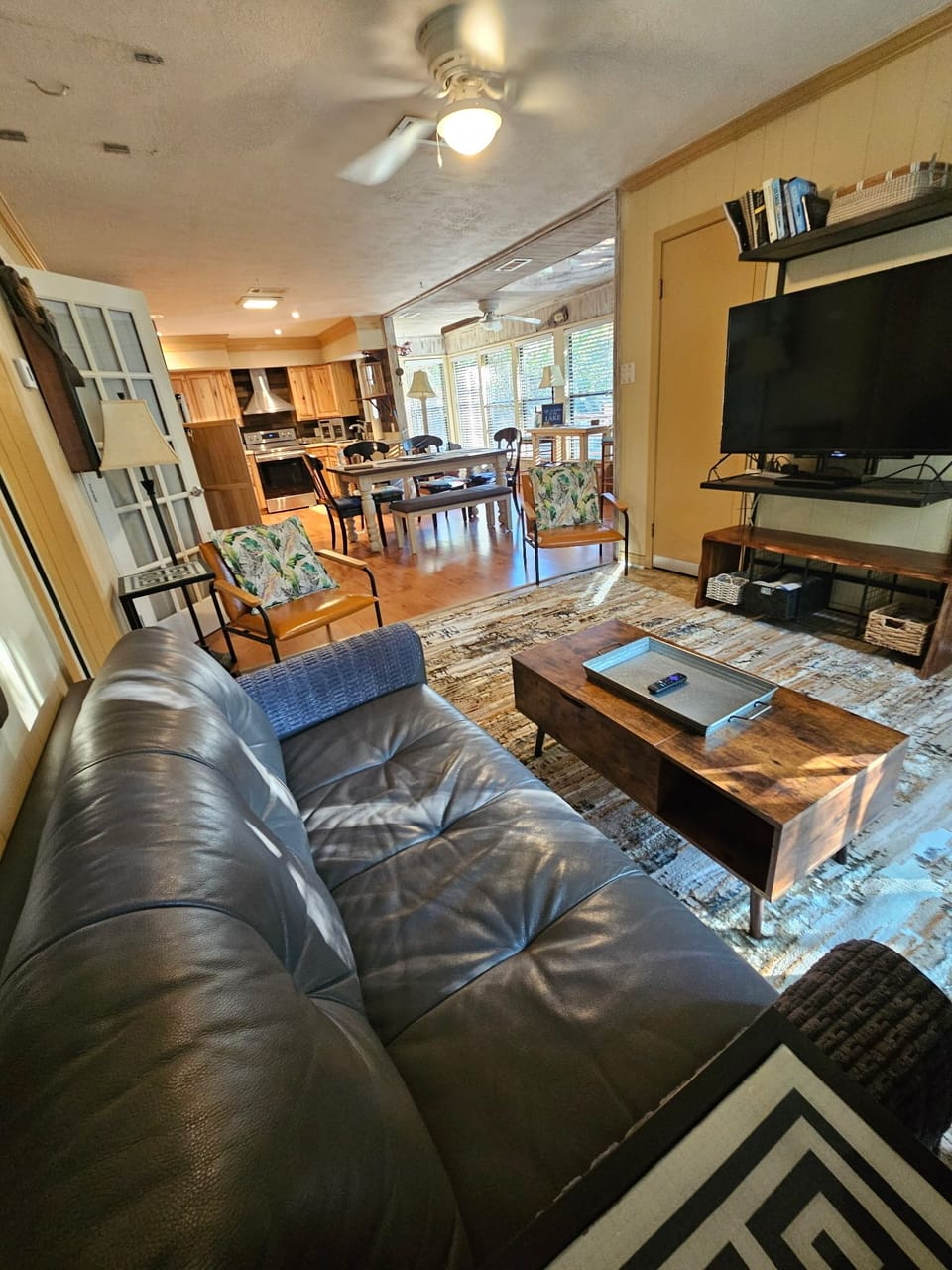 Open concept living area with living rm, dining, sitting/futon nook and kitchen.