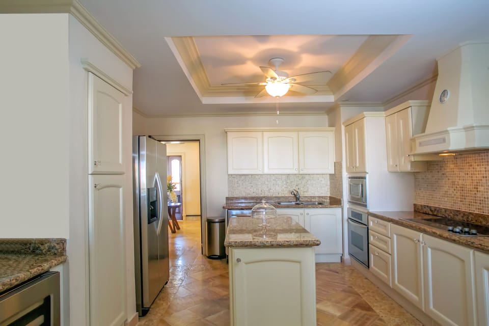 A view of the kitchen looking back at the dining area behind.