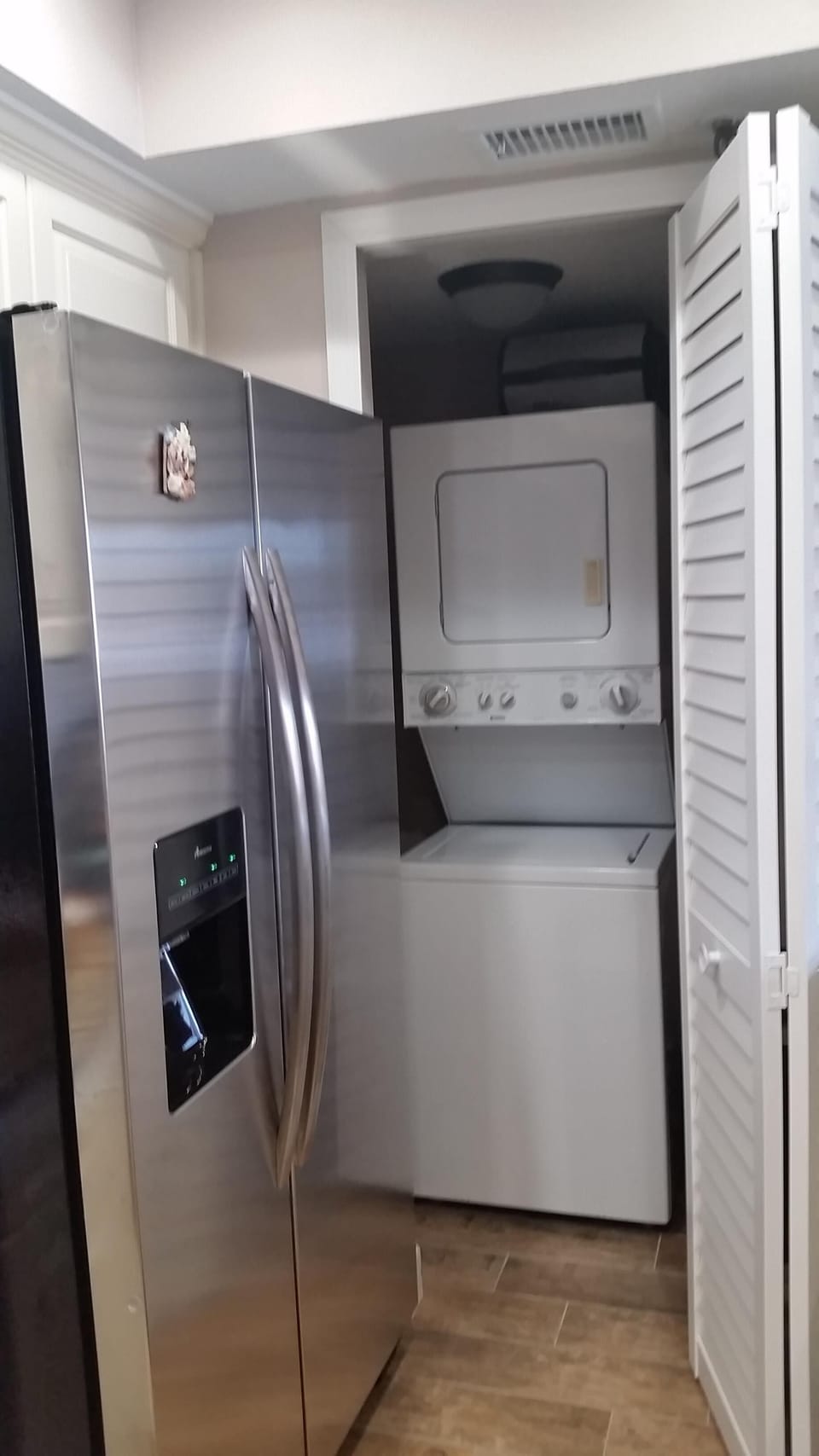 Stackable washer and dryer and pantry area.  