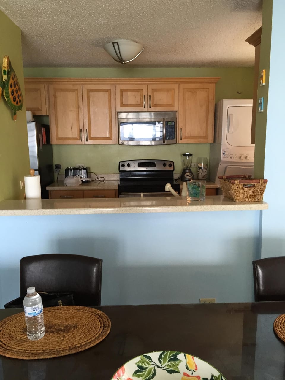 kitchen view from living room notice washer dryer on the right