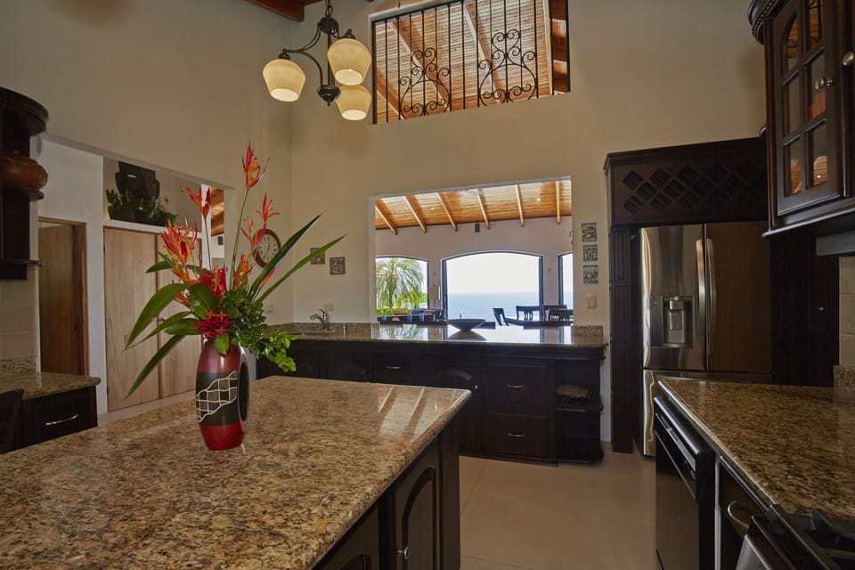 Chef’s kitchen with granite counters and stunning sightlines to the ocean