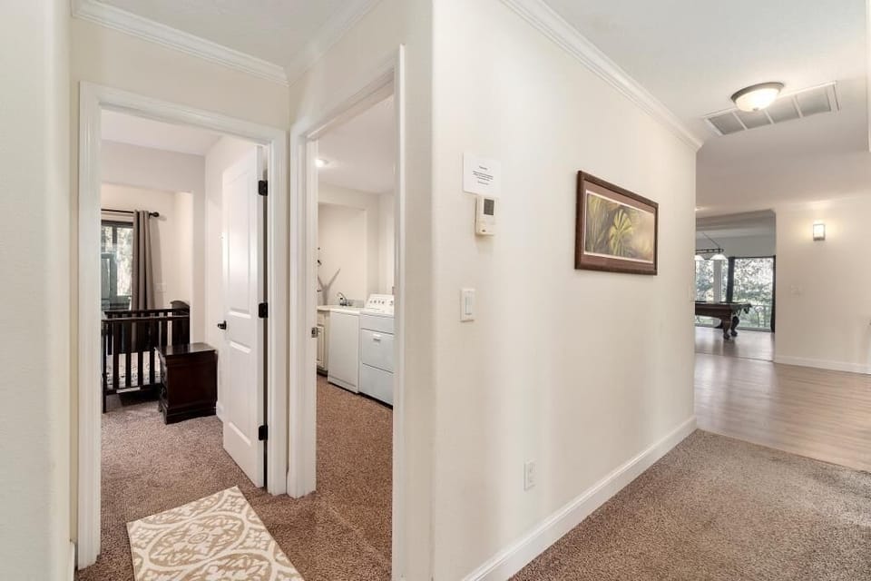 Hallway leading to 3 bedrooms and a laundry room