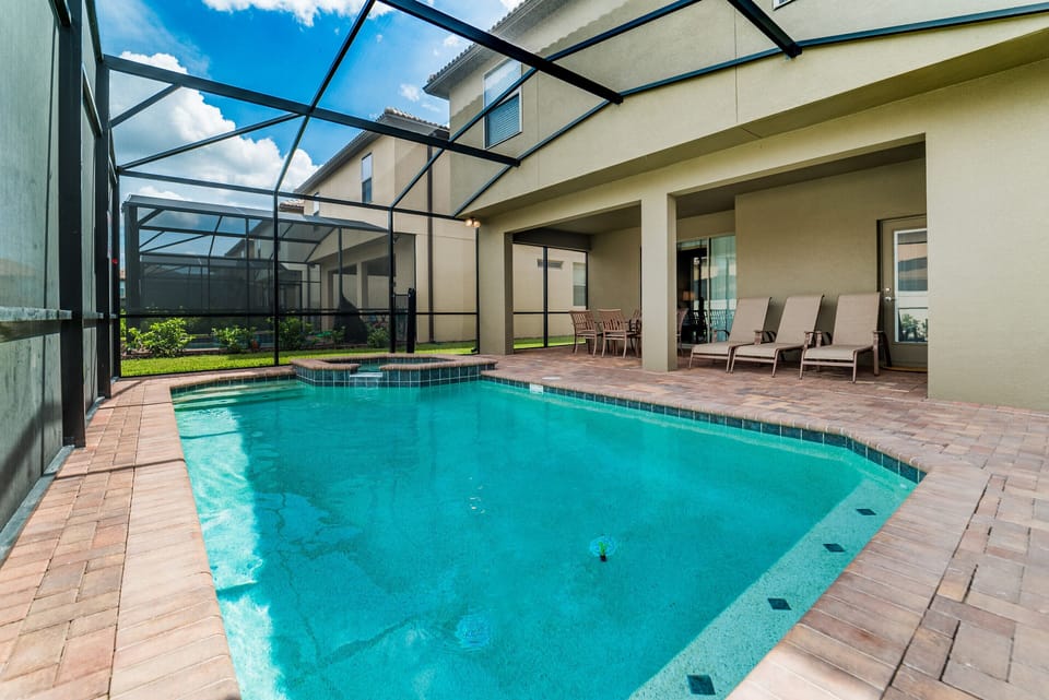 Back yard includes a private screened patio, with a pool and spa
