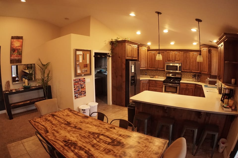 Kitchen and dining room table, seating for 8-10 people. 