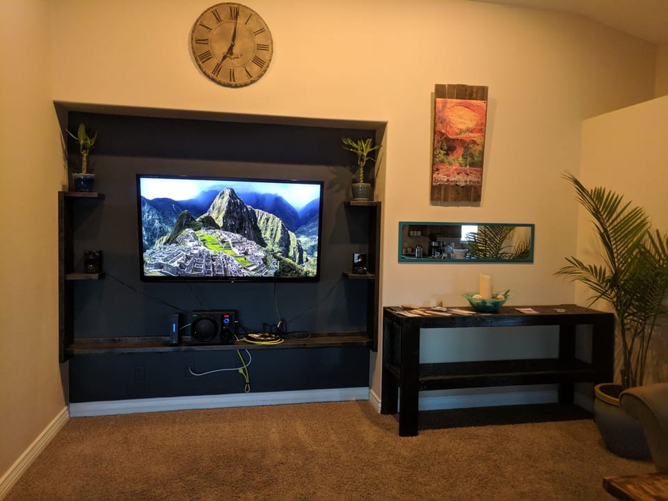 70" HDTV, entertainment center, and information desk with Zion guide book.