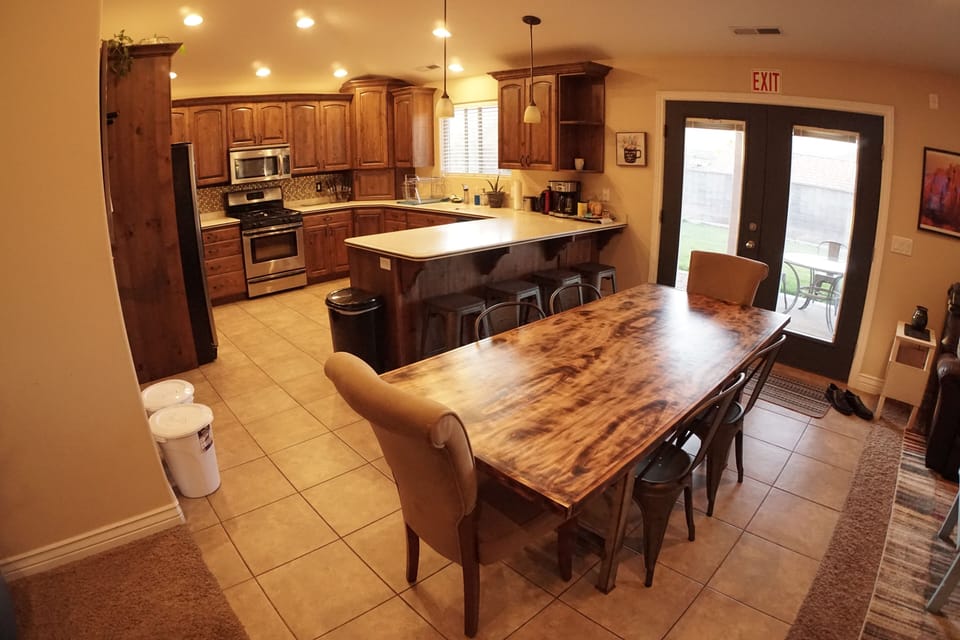 Kitchen and dining room table, seating for 8-10 people. 