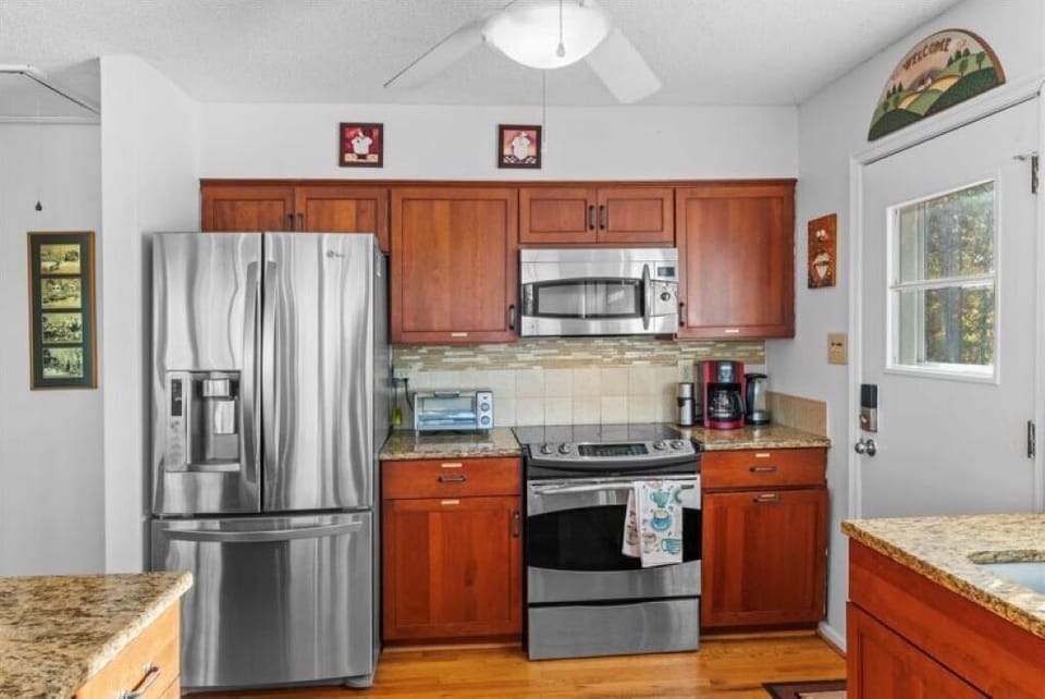 Granite countertops, stainless steel appliances and well stocked kitchen.