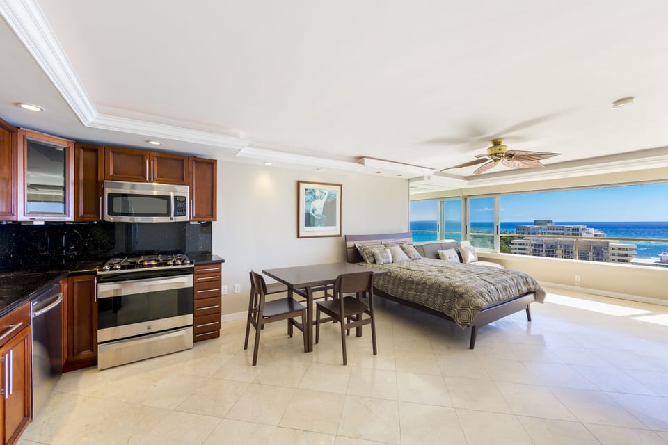 kitchen and dining area - Nicely equipped kitchen and dining table.  Sleeping area to the right with panoramic ocean views to take in and cherish forever.
