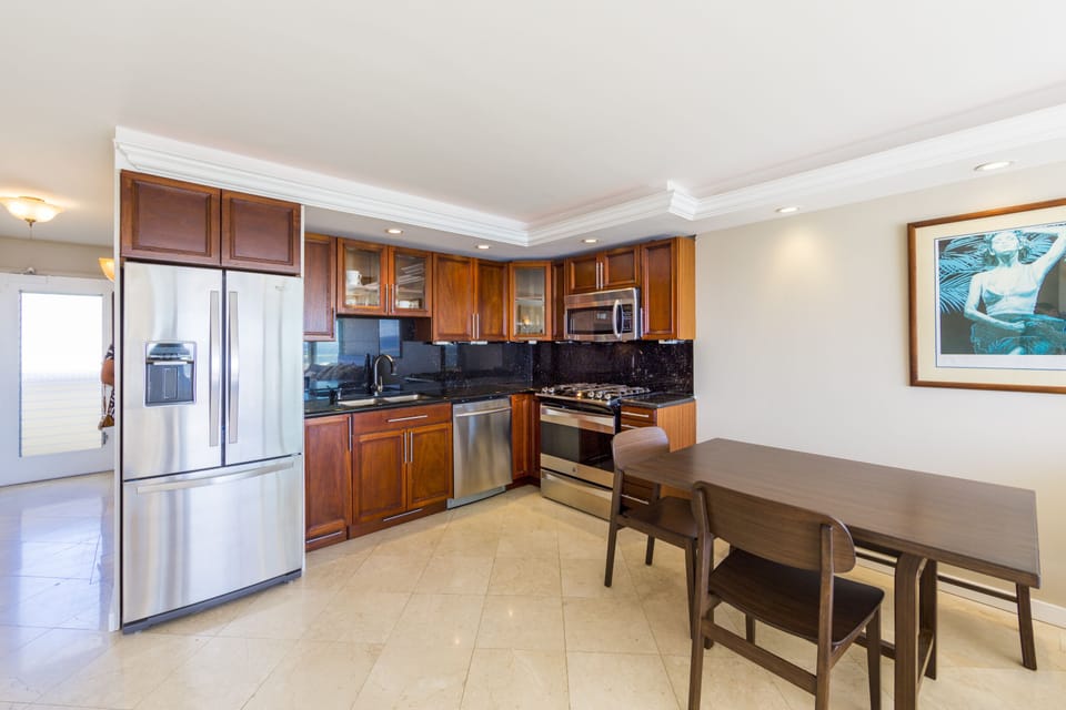 kitchen and dining area - Fully-equipped kitchen with stainless steel appliances for all your cooking needs.  Small dining table to the right.