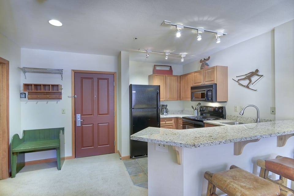 Entry- - Offers coat hooks, small bench, and shelves.