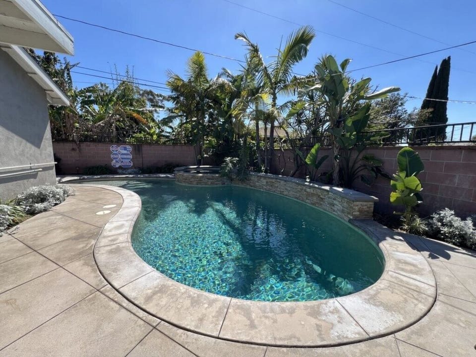 Beautiful Pebble-Tech Pool with Jacuzzi and Waterfall Feature