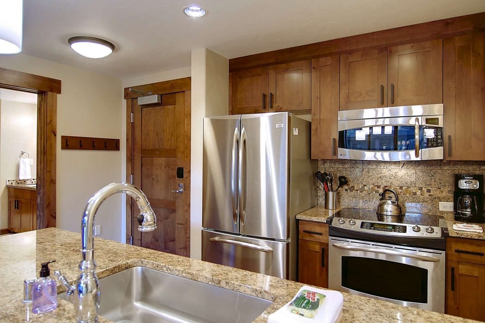 Modern kitchen fully equipped with stainless steel appliances, ample counter space, and all the essentials for effortless cooking and entertaining.