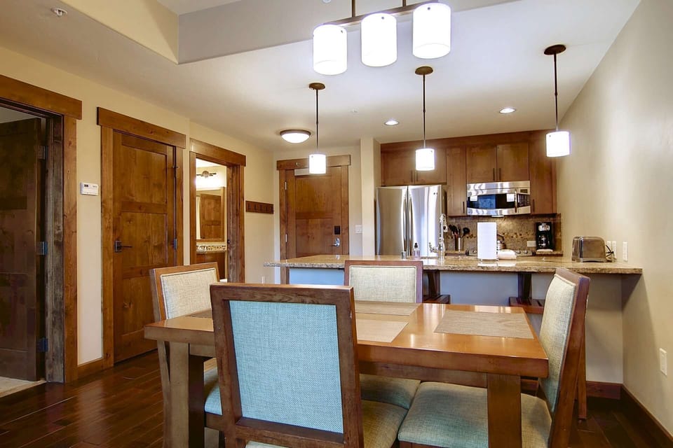 Comfortable dining area for four, plus two bar-stools, just off the kitchen—ideal for meals, games, or a relaxing morning coffee.