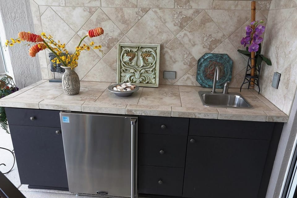 Counter in lanai with sink and refrigerator 