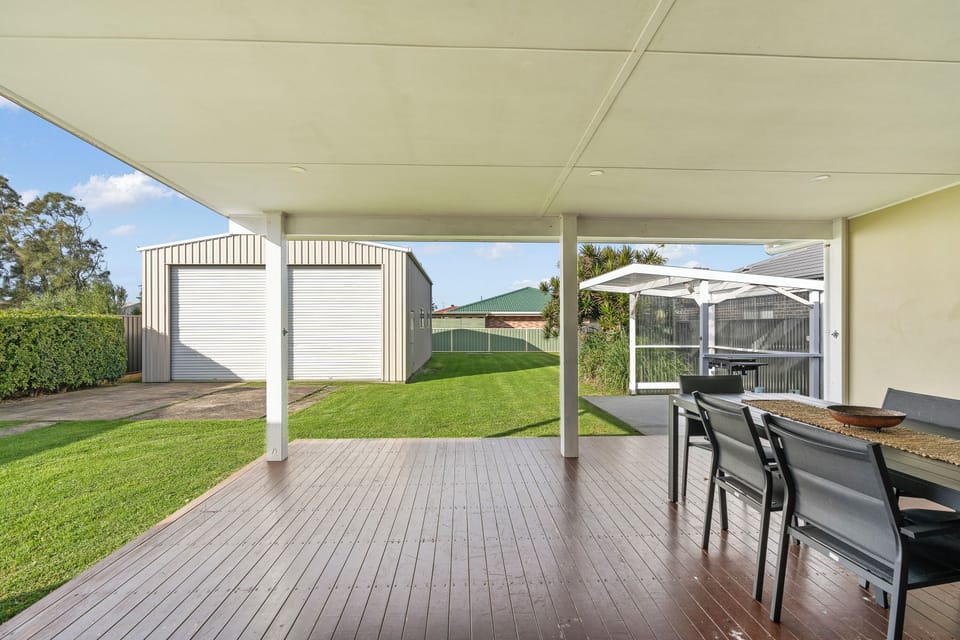 View out back sliding stacker doors to large flat grassed yard. Perfect for pets