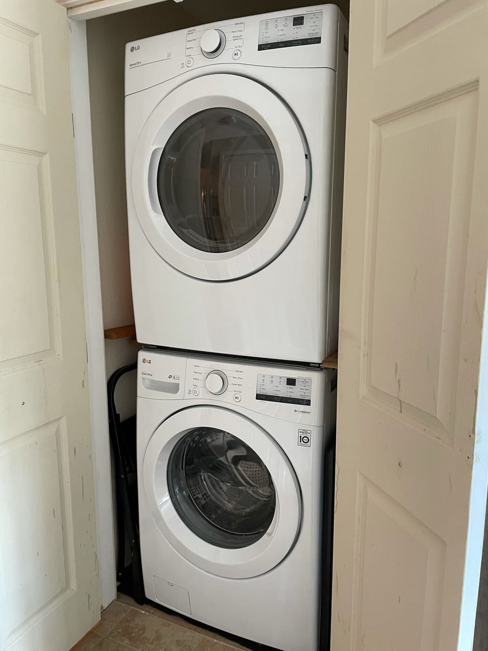 New stacked laundry center within unit closet