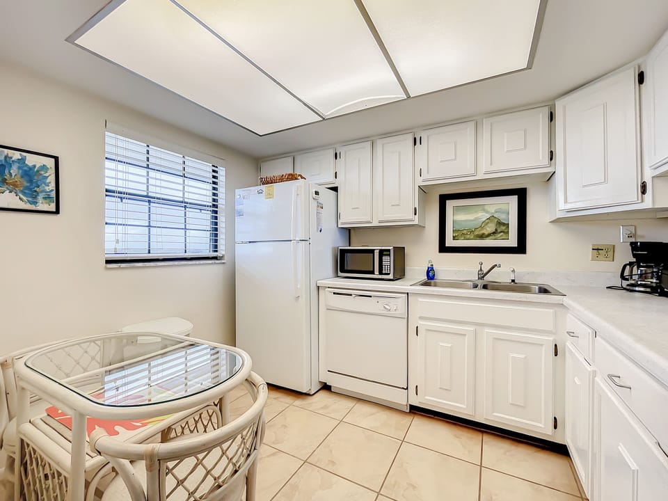 Full Kitchen with White Cabinet, Appliances, and Sky light