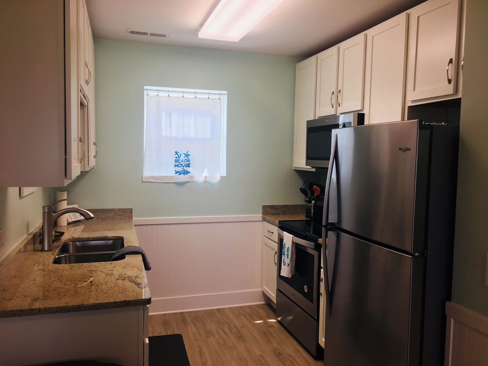 Kitchen view with all new stainless steel appliances.