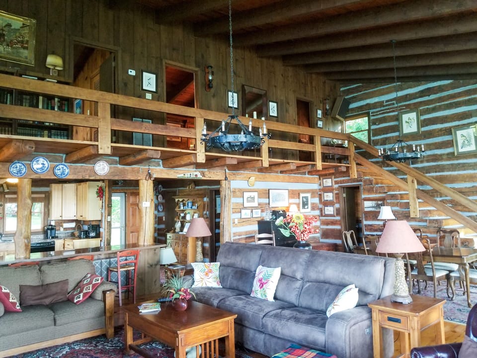Great room looking toward kitchen and second floor balcony