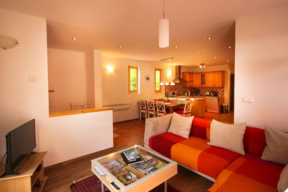 Living room looking into open plan dining area and kitchen