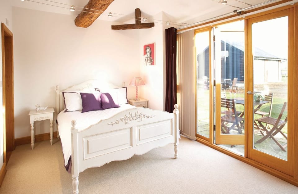 Ground floor:  Bedroom two with a king-size bed and en-suite bathroom