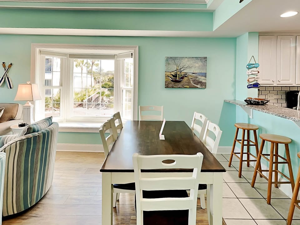 Dining area with table seating for 6 and bar seating for 4