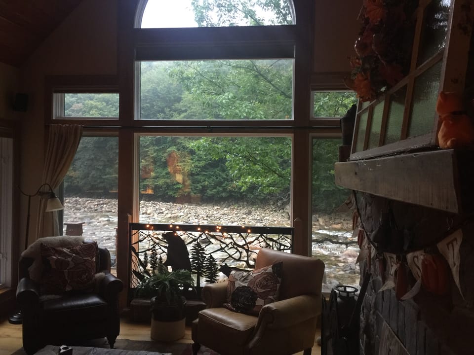 Read a book on the cozy couch with river views! Main floor living area