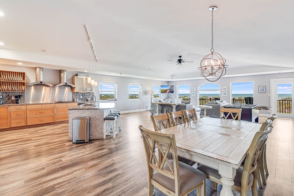 You'll love gathering around this spacious dining table with stunning ocean views streaming through every window, creating the perfect backdrop for memorable meals.