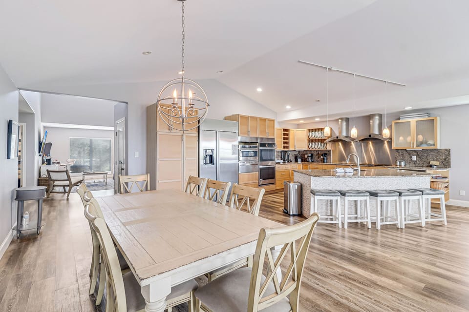 Your spacious dining area flows seamlessly into a gourmet kitchen, where marble counters and warm wood create the perfect gathering space for memorable meals.
