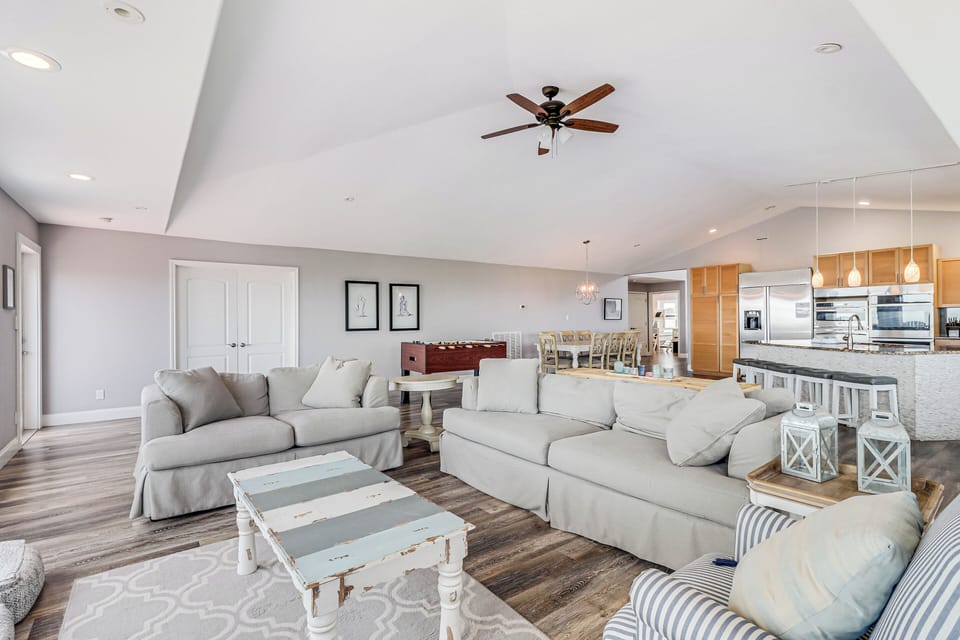 Relax in your spacious open living area with plush seating and seamless flow to your fully-equipped modern kitchen.