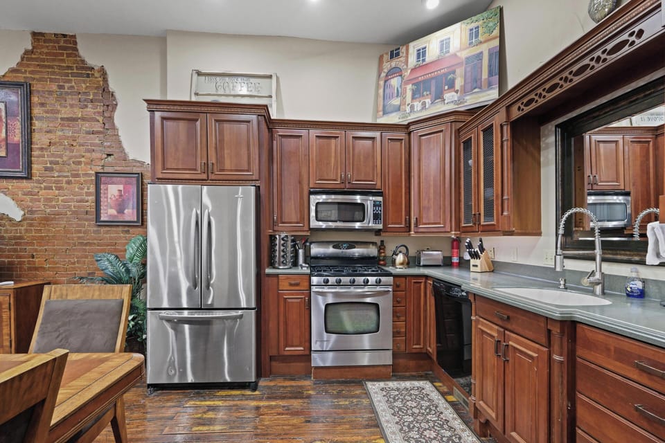 Gourmet kitchen with gas stove, two convection ovens, microwave, and dishwasher