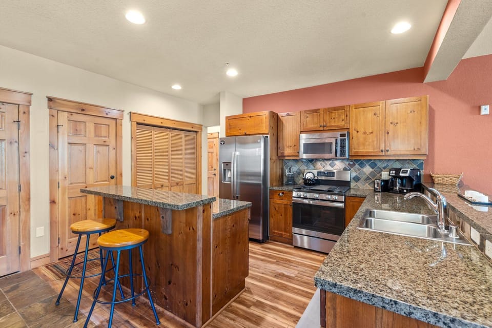 Full kitchen with stainless steel appliances.
