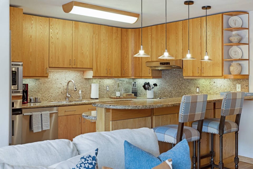 Cook and connect in the open kitchen, featuring modern stainless steel appliances.