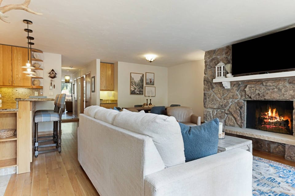 Cozy up by the wood-burning fireplace in the inviting living room.