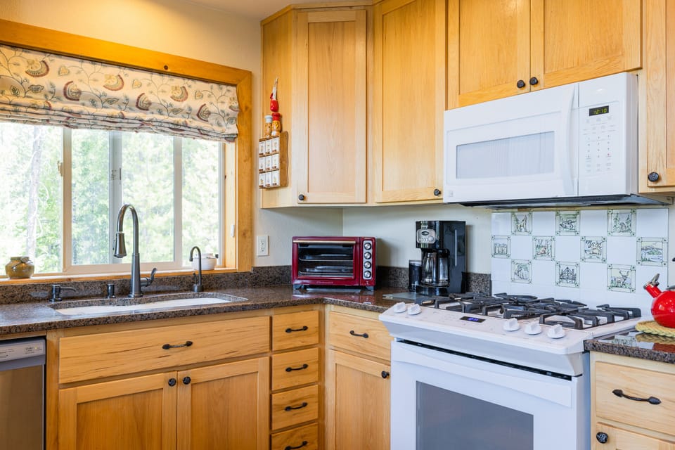 Fully stocked kitchen with drip coffee maker and coffee bean grinder