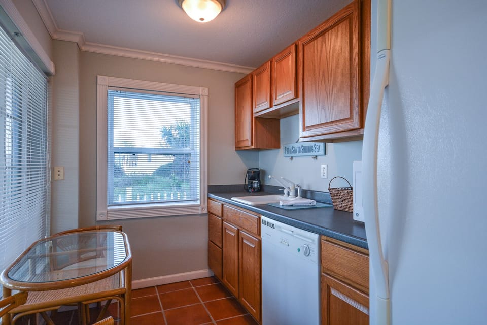 Downstairs galley kitchen with seating for 2.