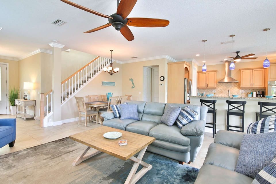 Large open living space with flatscreen TV that opens up to the pool area.