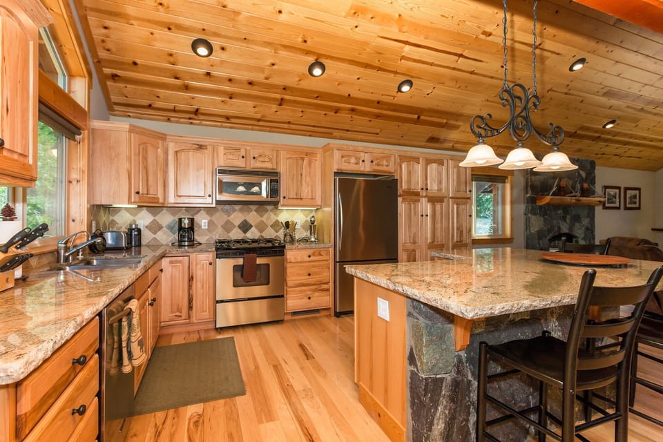 Spacious kitchen with granite counter tops and stainless steel appliances