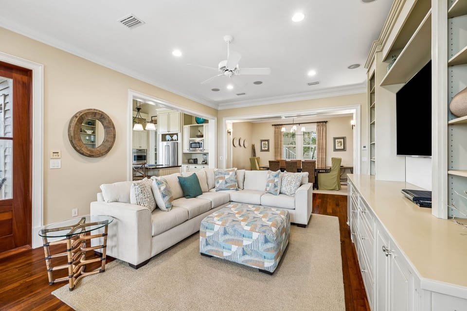 Relax in your spacious open-concept living area, where plush seating, coastal accents, and seamless flow into the kitchen and dining spaces create the perfect setting for gathering and unwinding together.