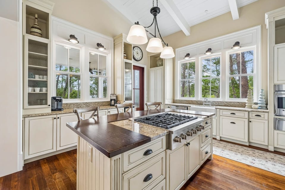 Your gourmet kitchen features granite countertops, a large gas range, elegant cabinetry, and abundant natural light—perfect for preparing meals with friends and family.