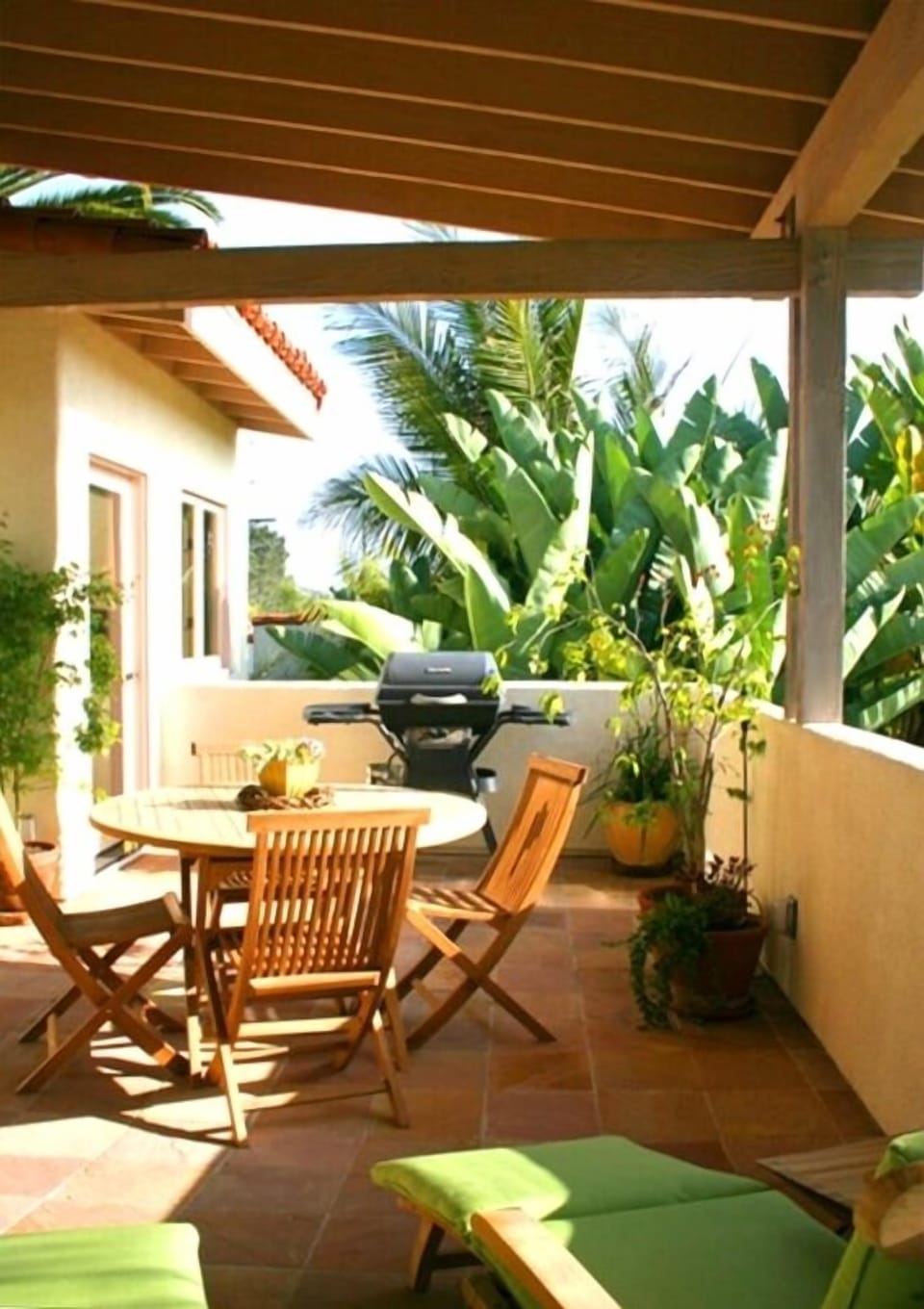 Large deck with teak dining and loungers.