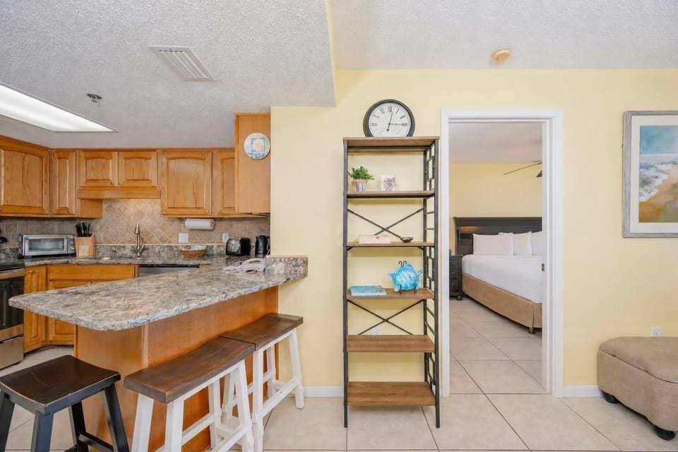 Enjoy your morning coffee at this breakfast bar in this inviting kitchen
