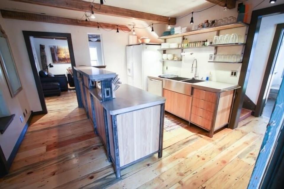 The kitchen, looking back at the living room.  Stairs are visible on the R